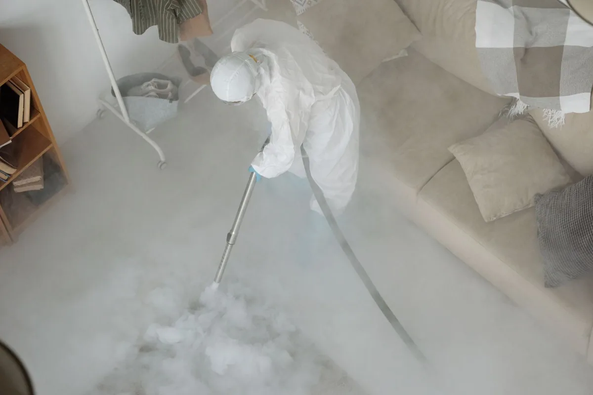Biohazard cleanup technician in protective equipment, Monte Alto, TX